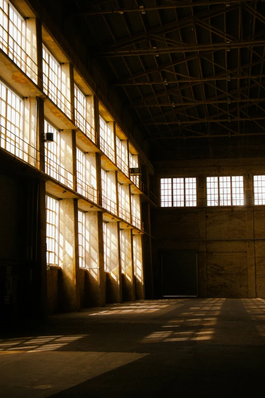 a warehouse has three long windows all inside of it