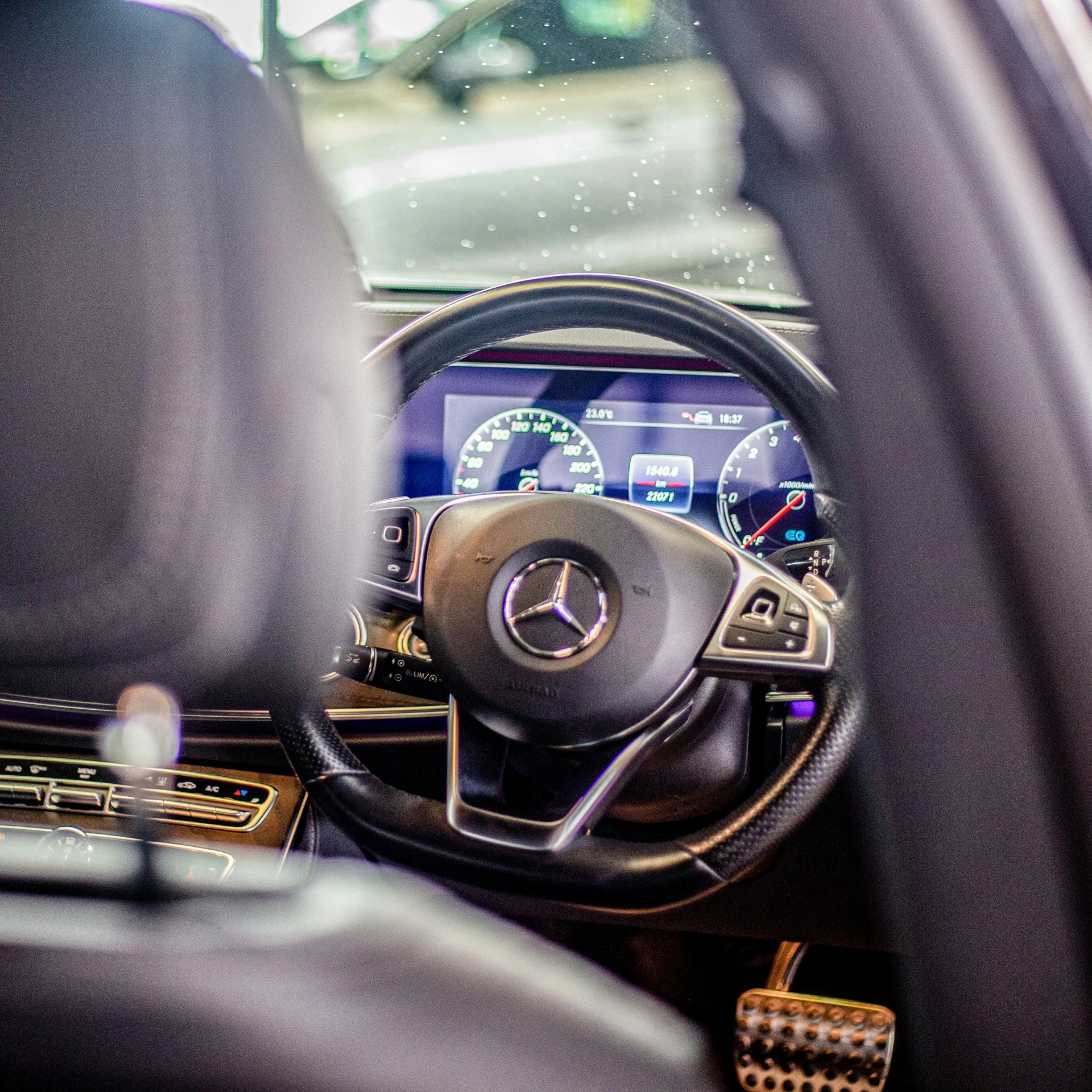 inside the car is a steering wheel, dash board and display monitor