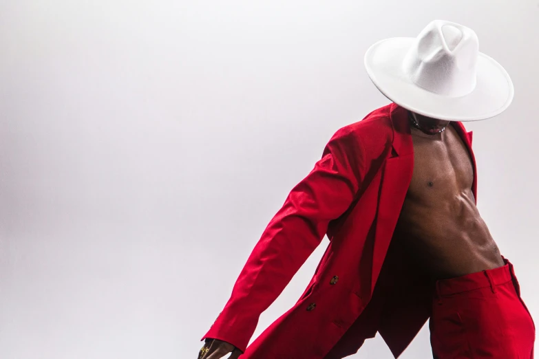 a man wearing a red coat, white hat and red pants