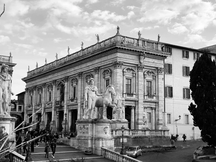 black and white po of a building with statue in front