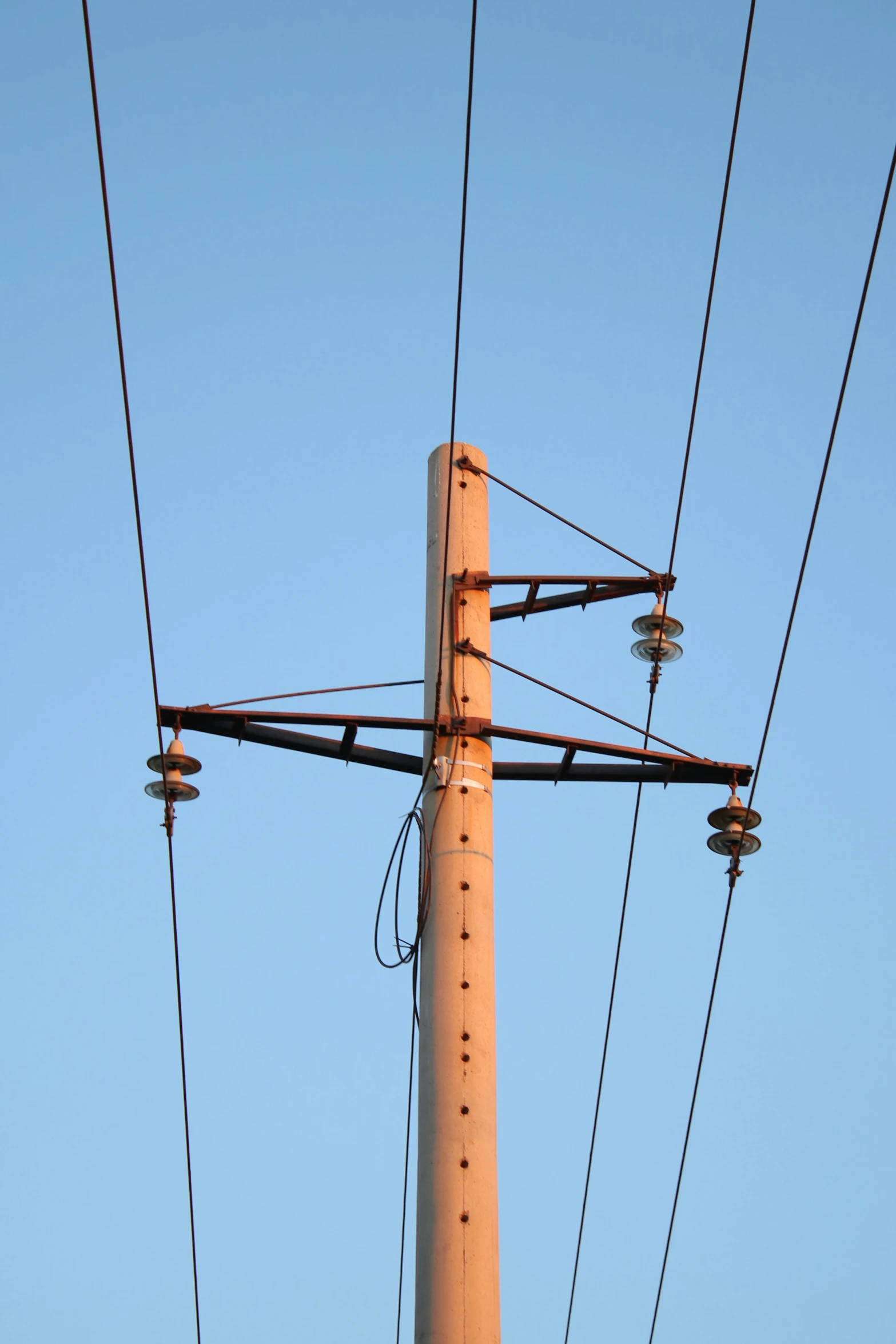 the telephone wires are hanging in an upward position