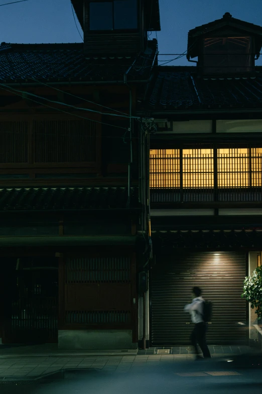 a person in an alley way next to a tall building