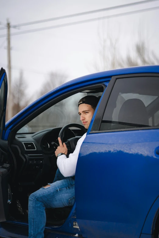 a man sitting in the driver's seat of a car