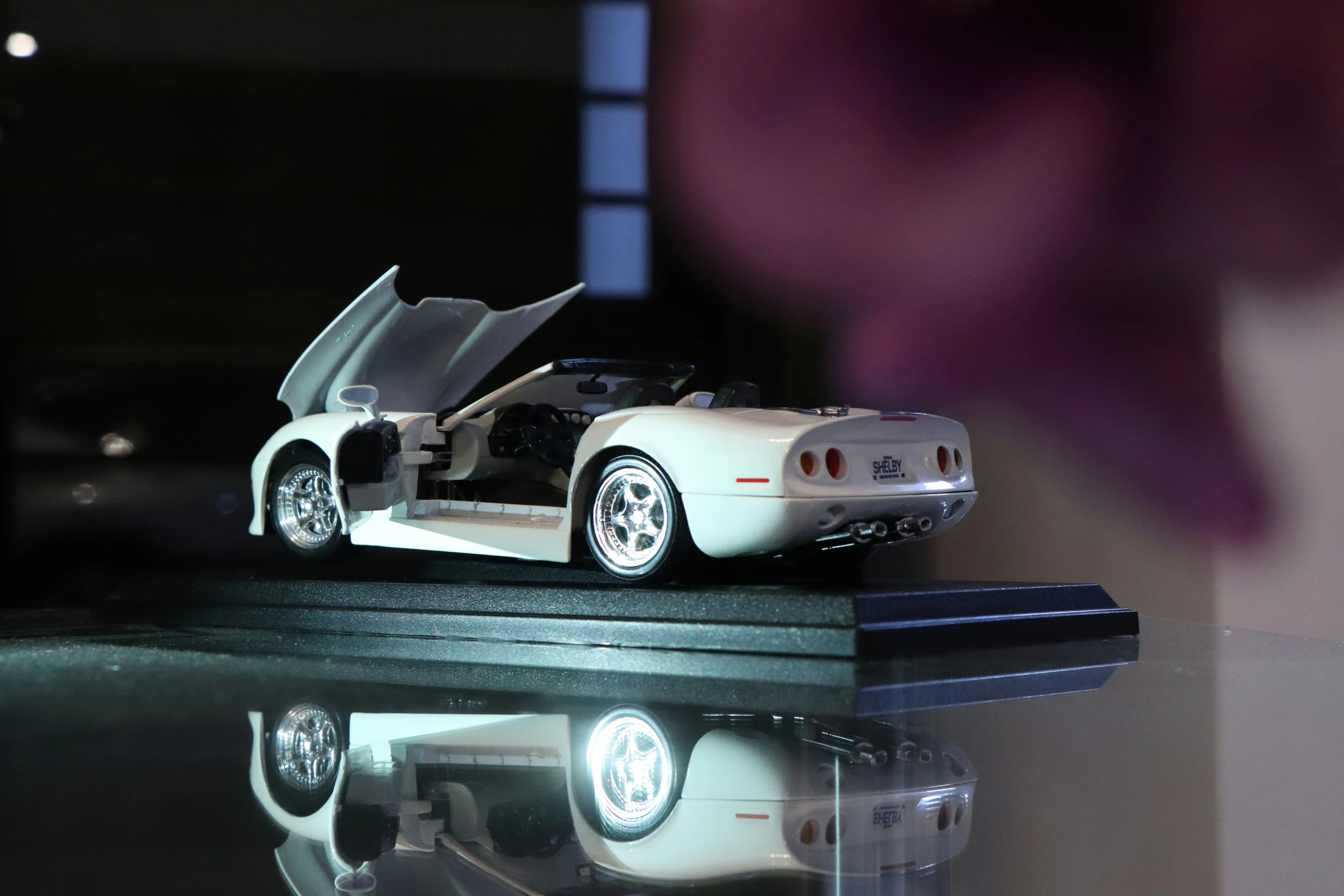 a close up of a white car parked on top of a table