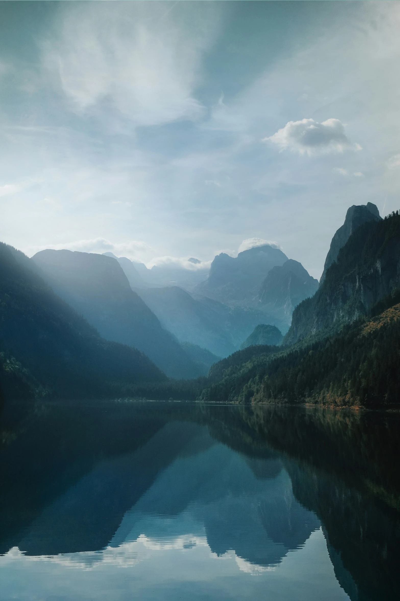 the beautiful blue water in the mountains is reflecting the sky