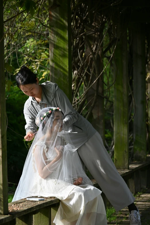 a man and a woman pose for a pograph on the bench