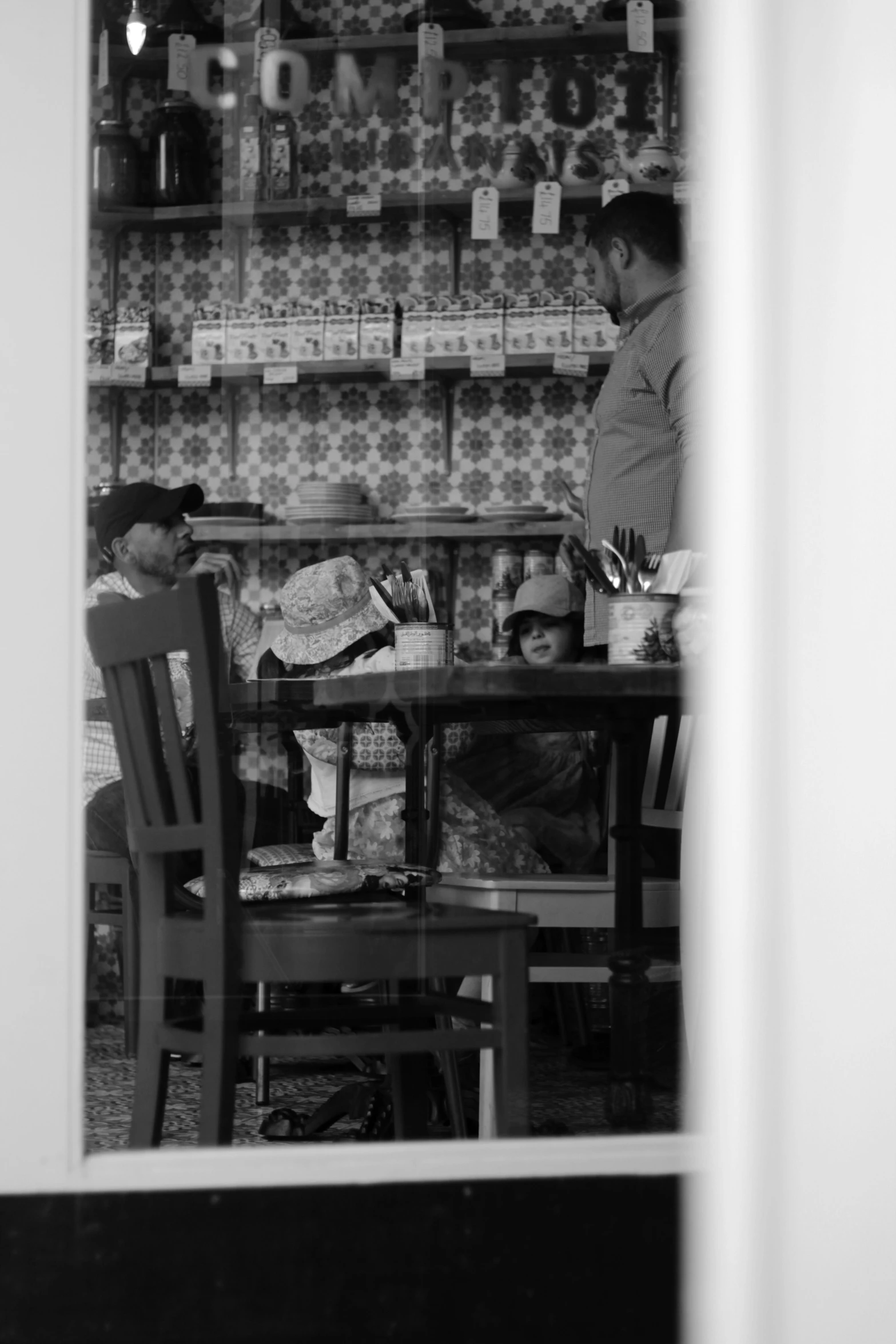 a person and two boys are sitting at the table