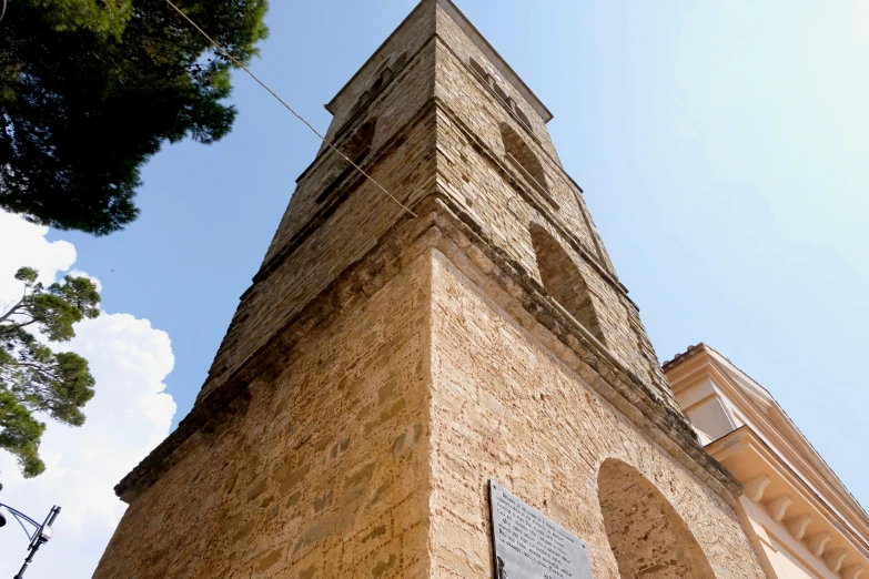 an old church tower is shown against a clear blue sky