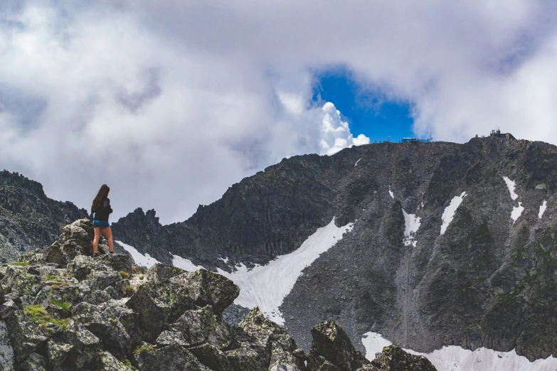 there is a person standing on the edge of a mountain