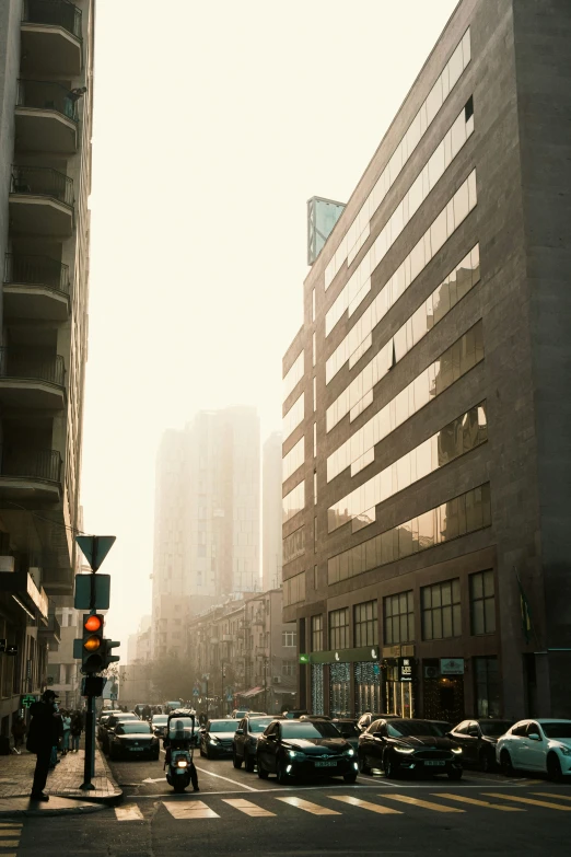 a po of a city street intersection with cars on the road