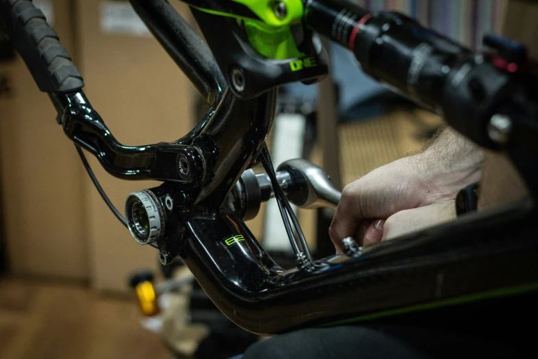 a hand holding the handle bars on a bike