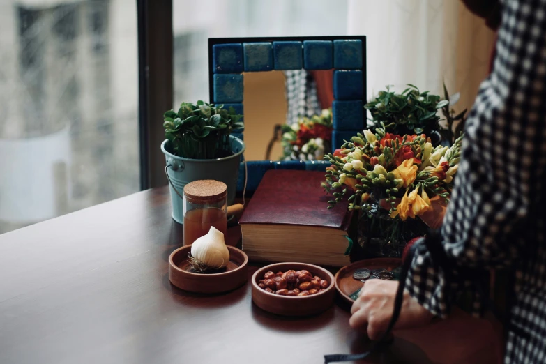 a person  onions near a table with plants