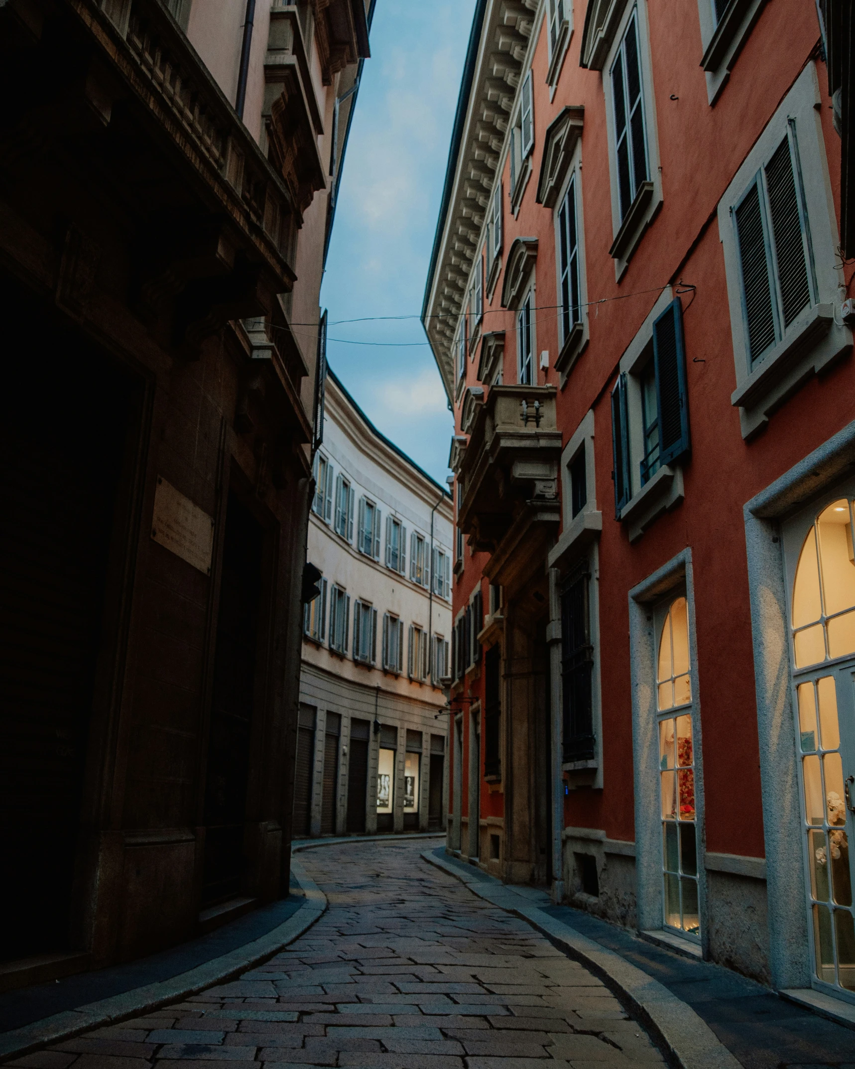 the streets in front of two buildings are very narrow