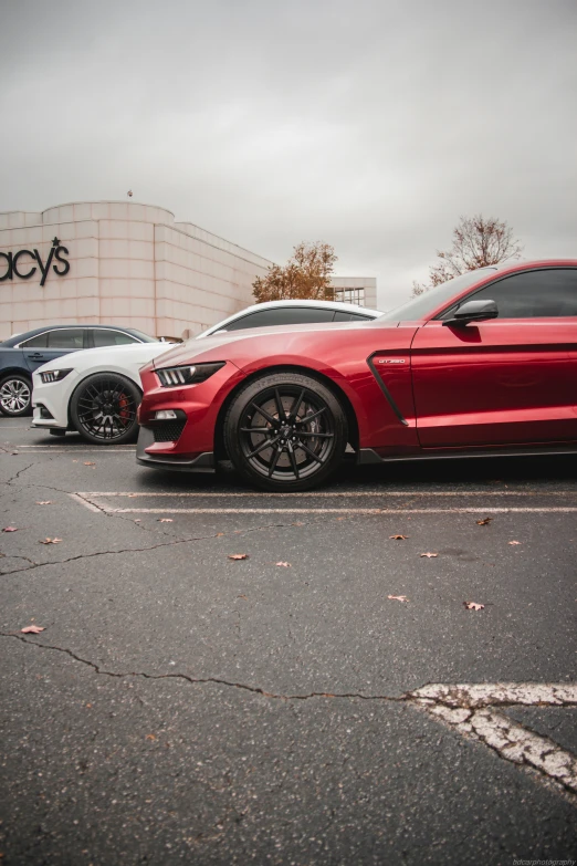 a large, three car parking lot with a ford dealership in the background