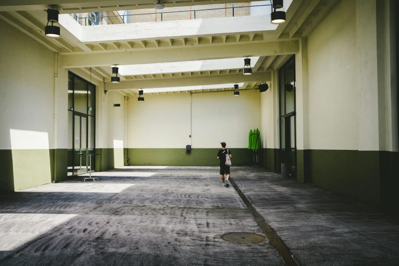 a person is walking along an empty hallway