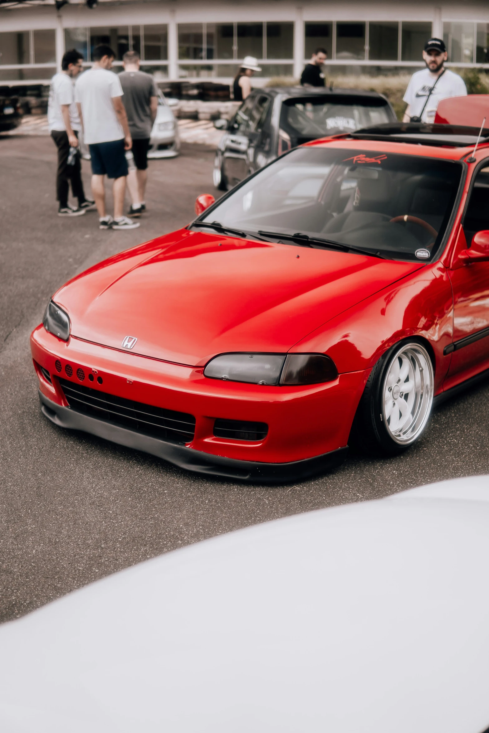 there is a red car that is parked in the lot