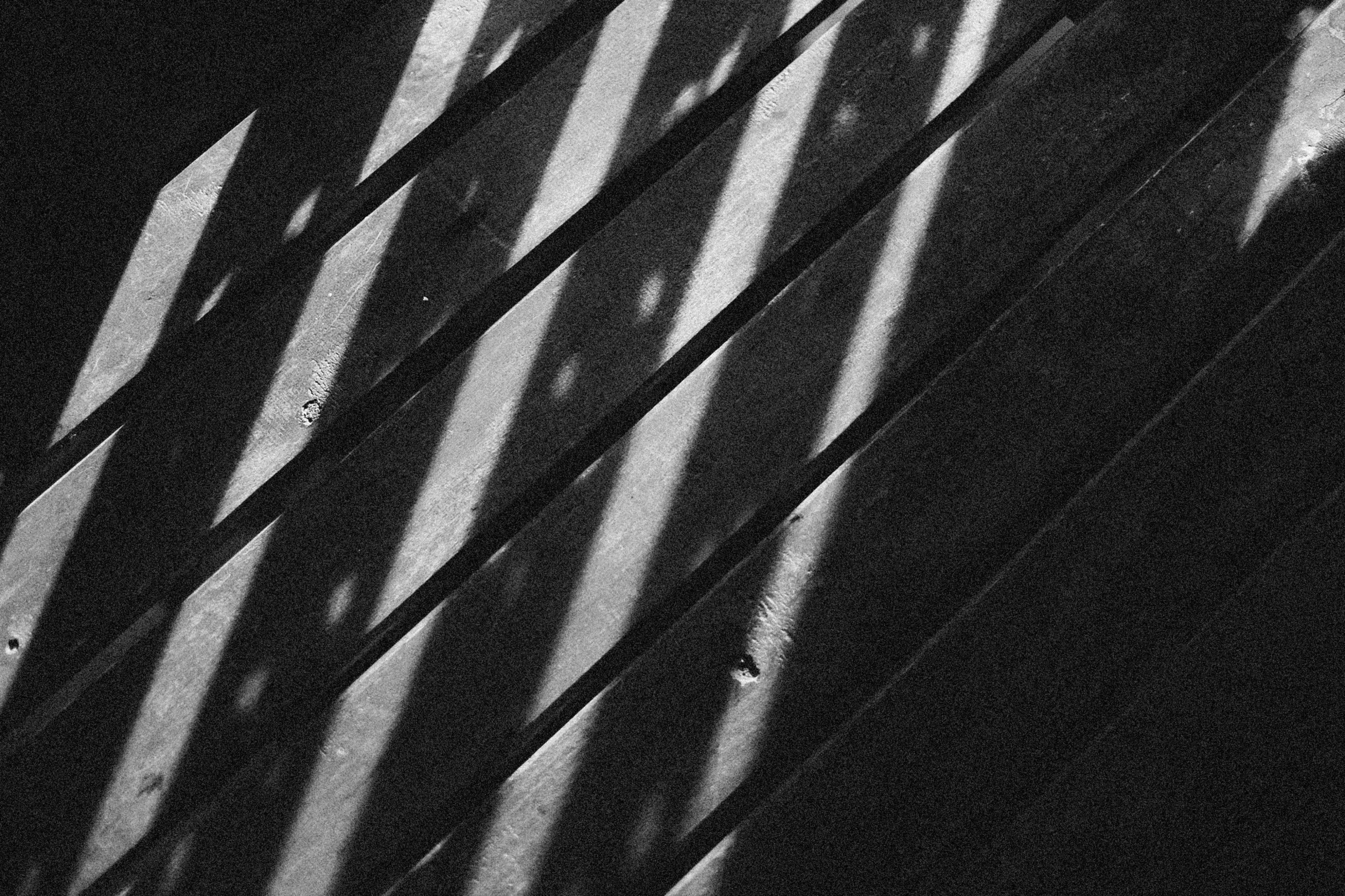 the shadows on a tiled floor are cast by a wall