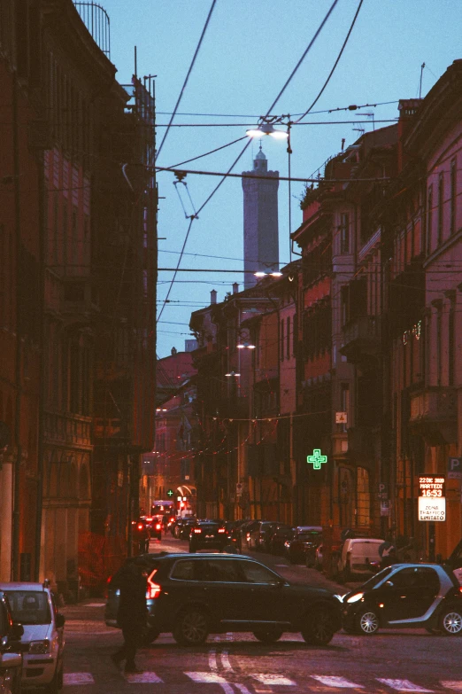 a very long view of a city street with a clock tower in the background