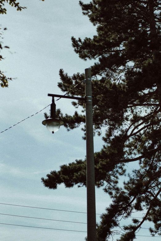 a street light with a telephone wire below