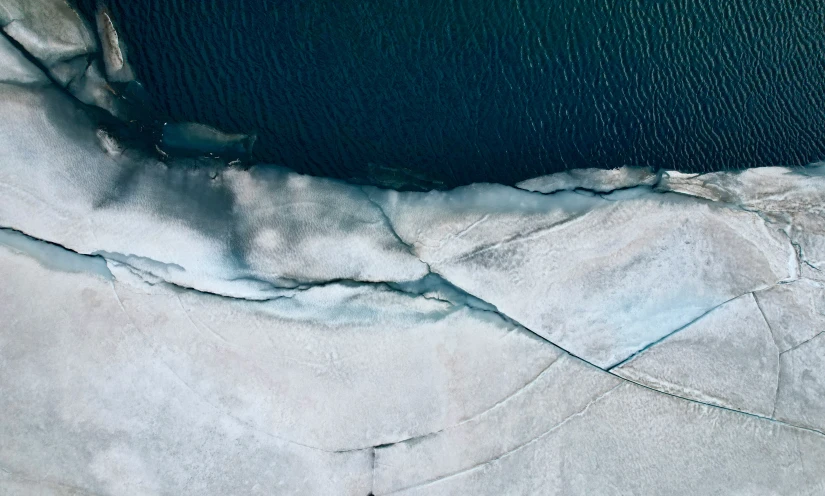 a frozen lake and ice covered beach near the shore