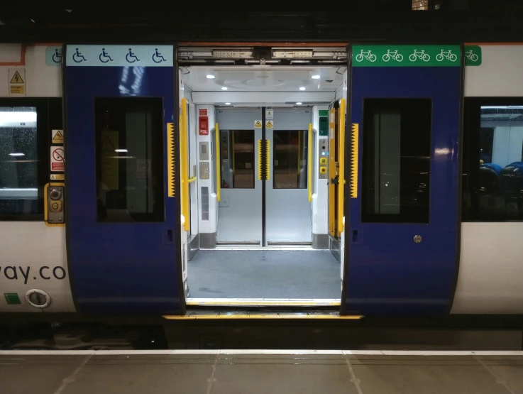 a blue and white train car with doors open