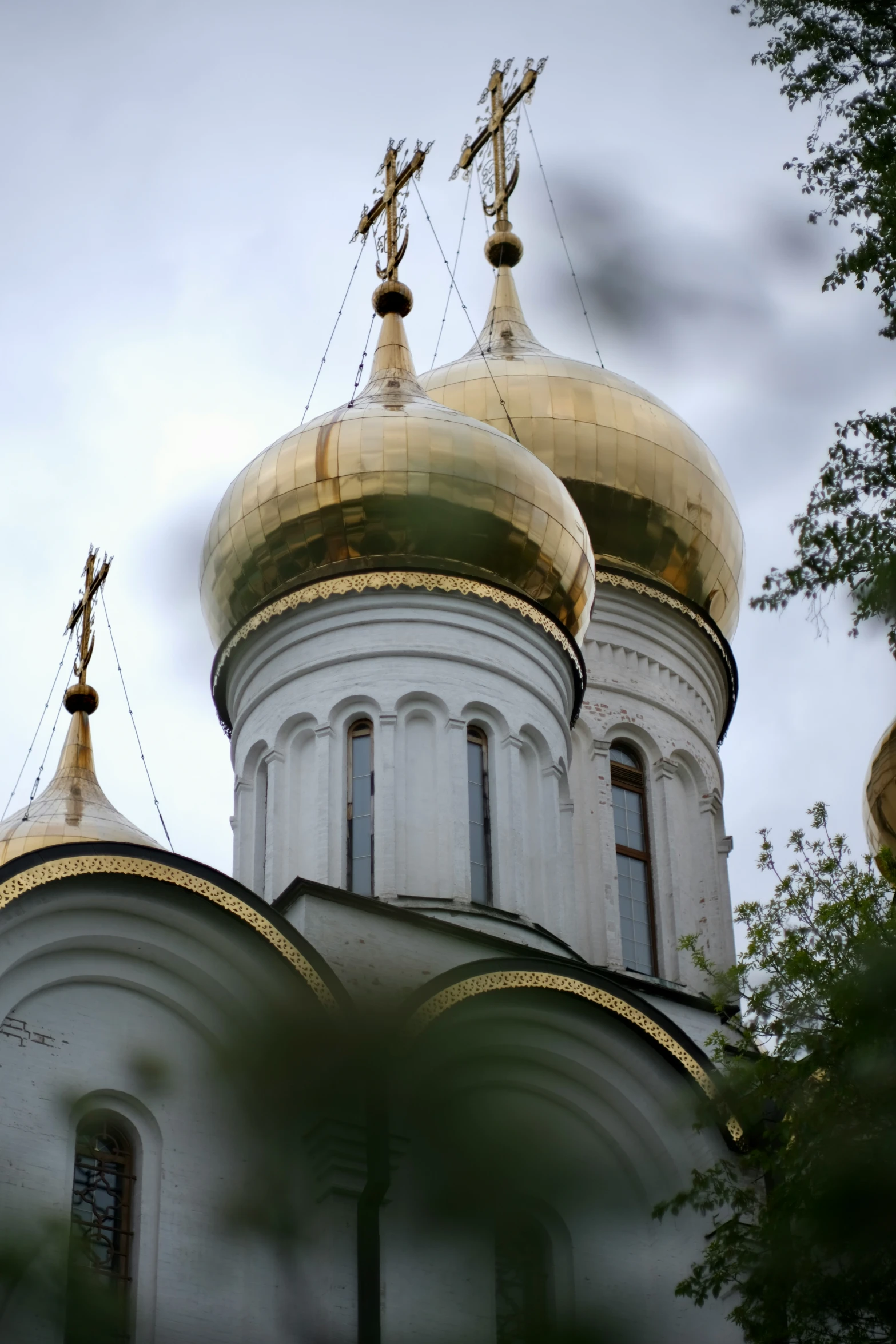 there are two gold and white domes atop the church