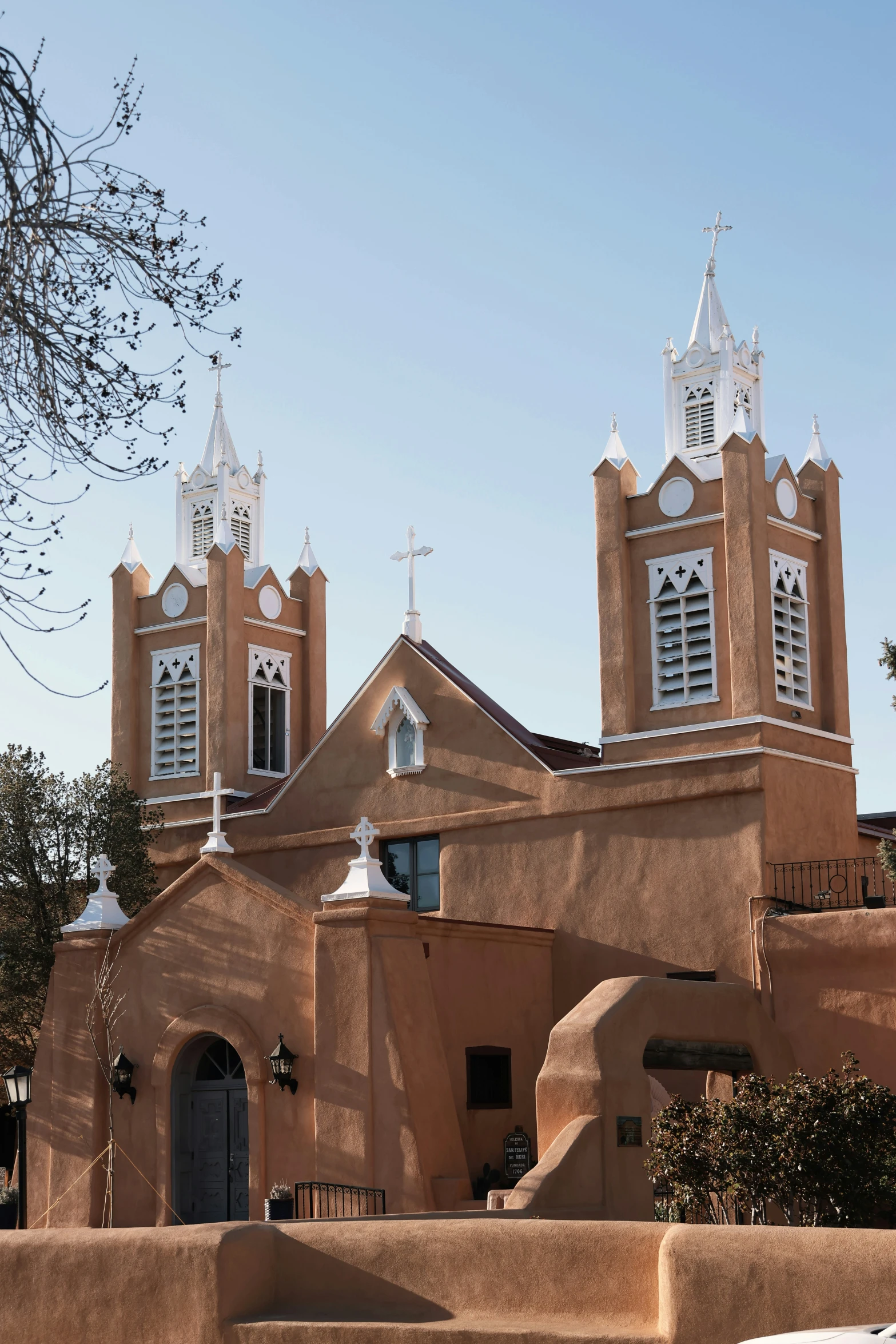 an old church with two windows in a mexican styled setting