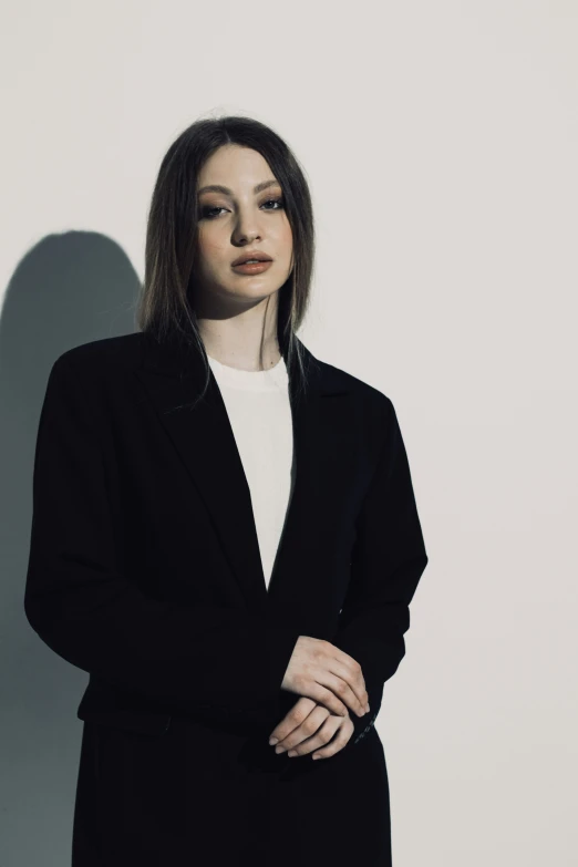 a young woman wearing a suit is posing for a picture