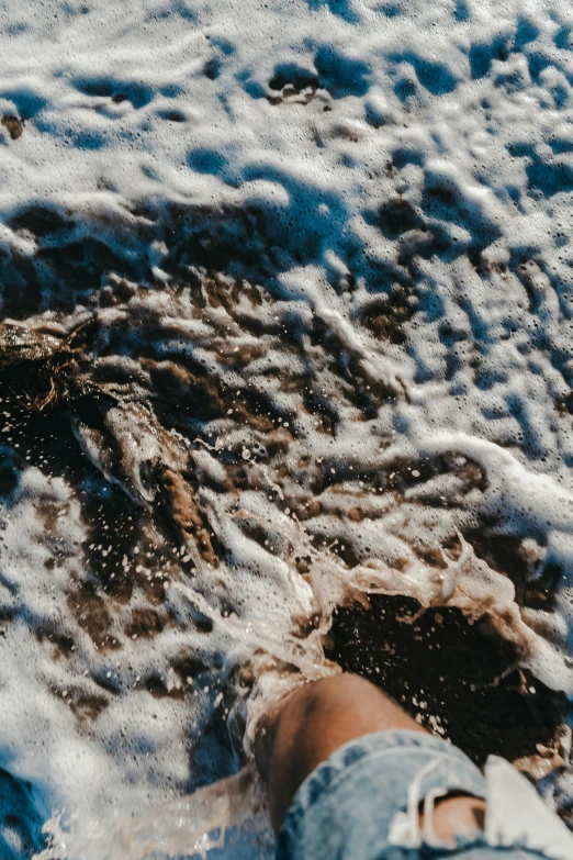 someone standing on a sandy beach covered in snow