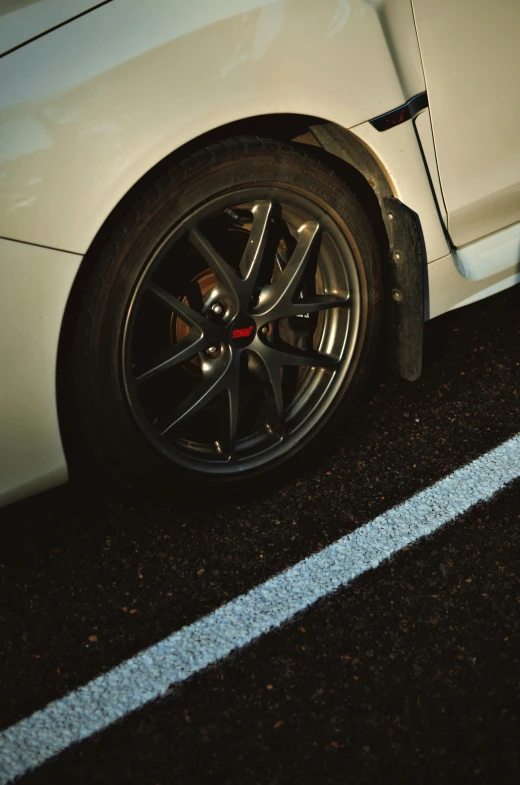 a tire on the side of a white car