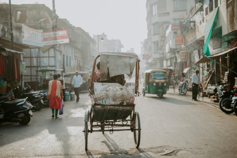 a street in the city with people and a rickshaw