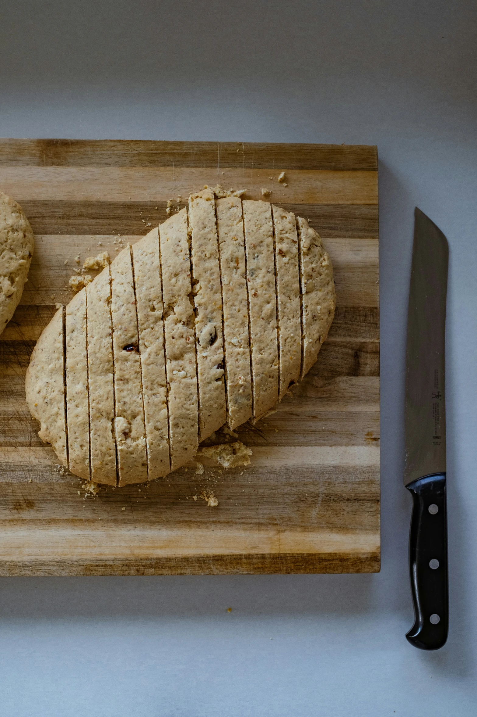 a knife is next to some bread on a board