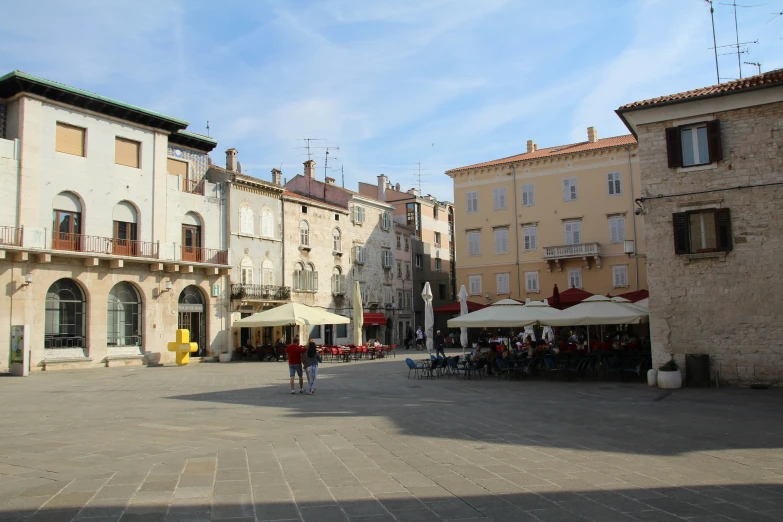 the sidewalk view of some buildings in a city