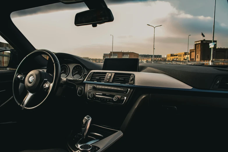 a view of the dashboard and steering wheel from the driver seat