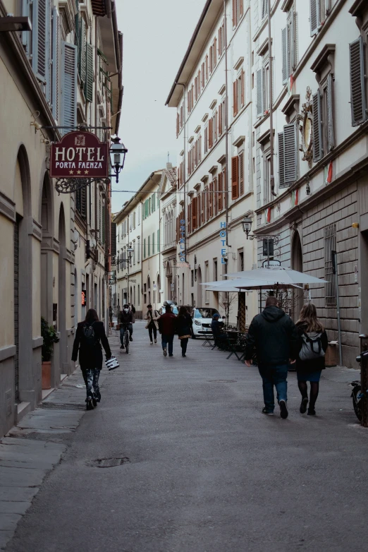 a group of people walking down a street