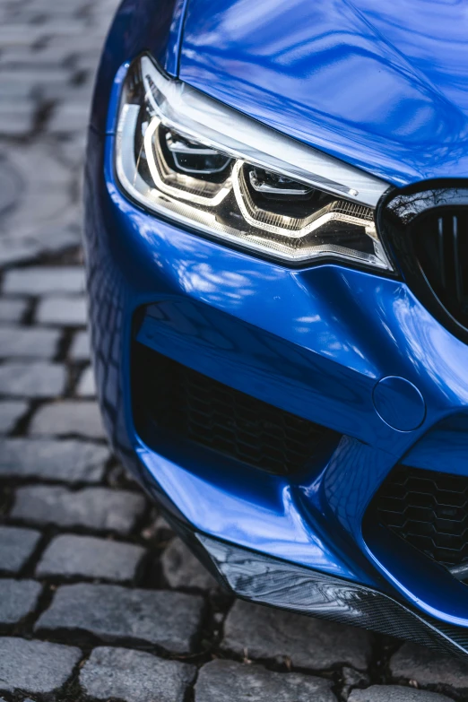 a close up view of the front of a blue bmw vehicle