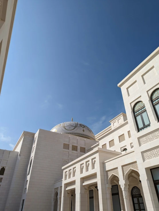 an elegant white building on a sunny day