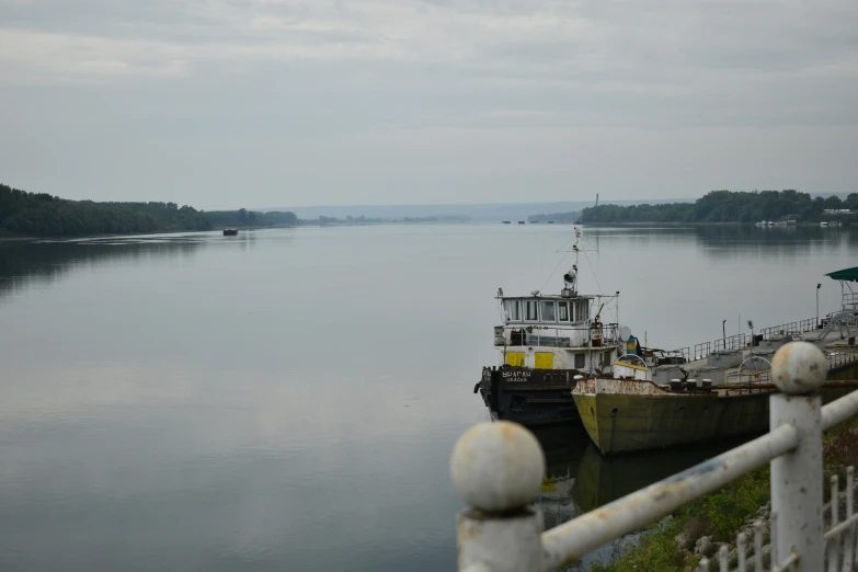 a barge sitting at the dock in front of a house