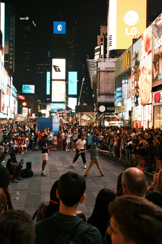 a large crowd of people and various signs and buildings