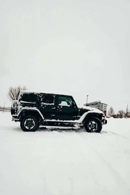 a jeep that is covered in snow during the day