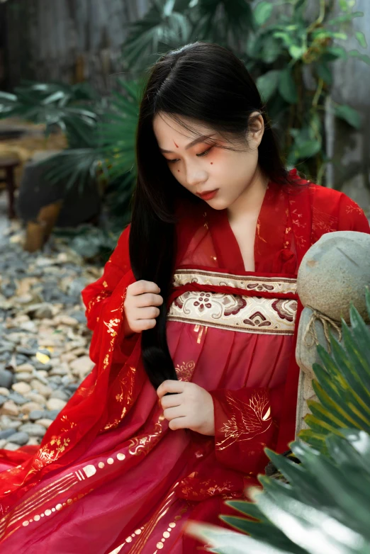 a young lady wearing a red oriental outfit