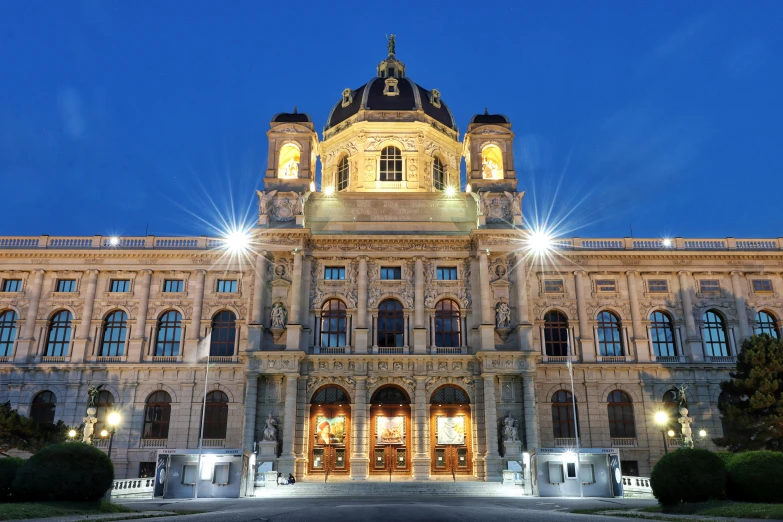 a large building with many windows and lights on