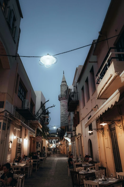 an alley leading to some restaurants during night