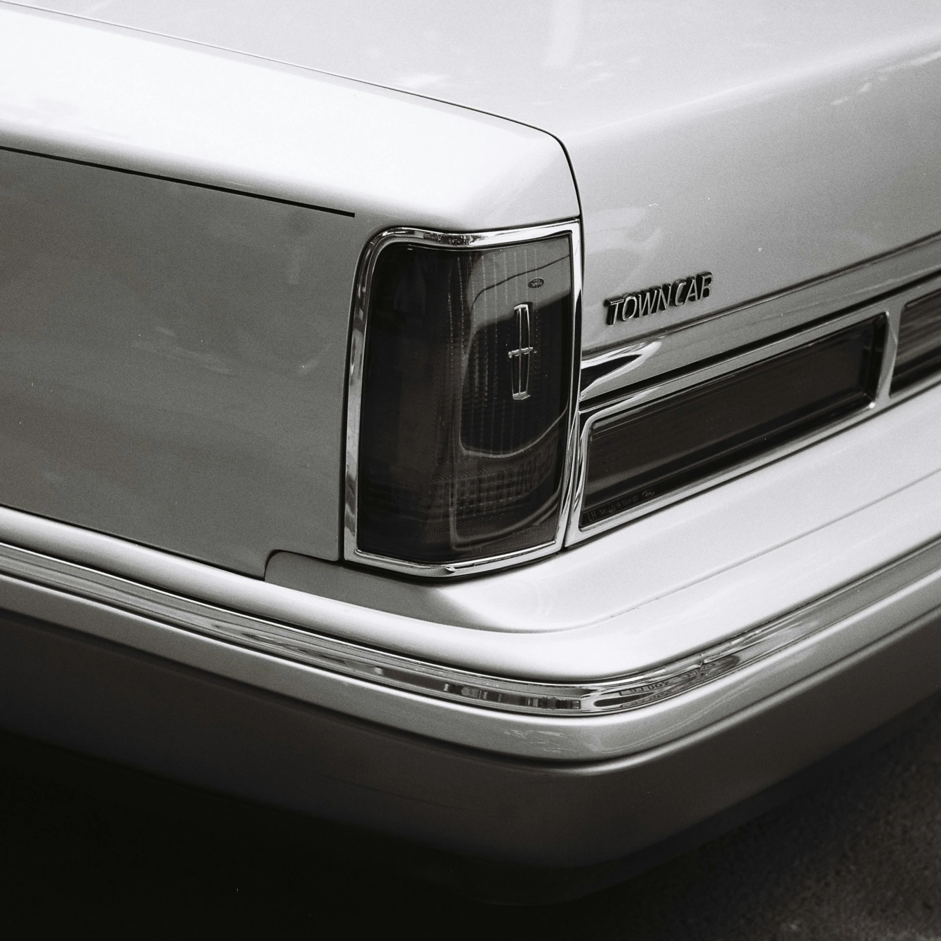 an older silver van is sitting near another car