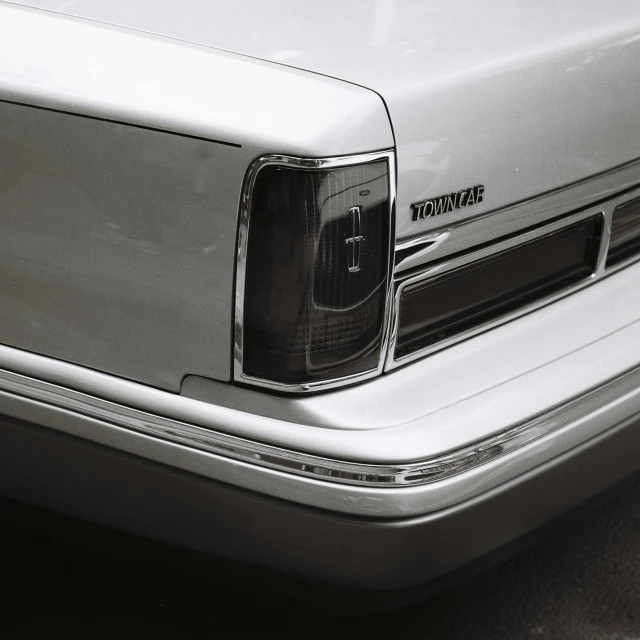 an older silver van is sitting near another car