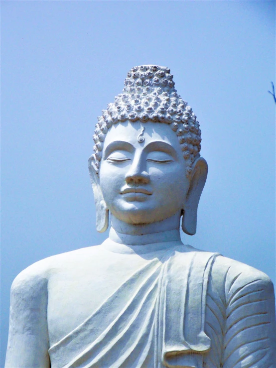 a buddha statue with it's eyes closed