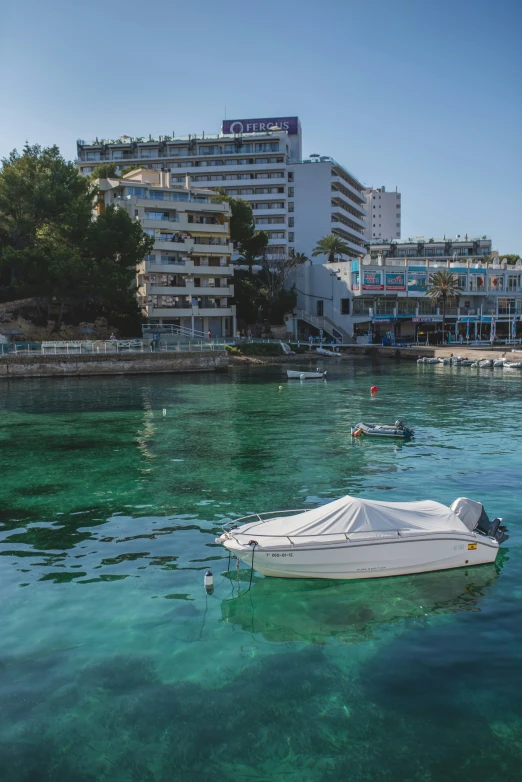 two boats that are floating in the clear water