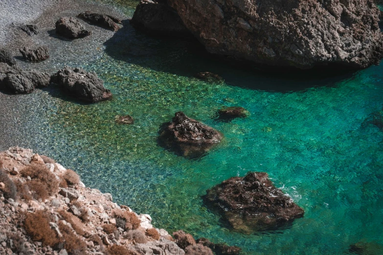 a beach area with some water and rocks