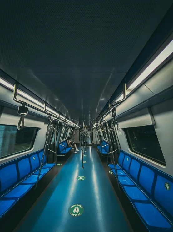 the blue train is in an empty subway area