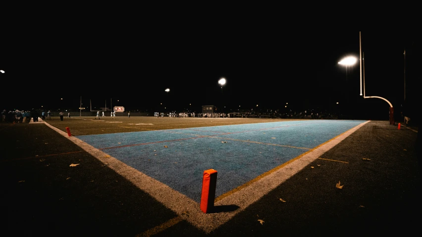 a lighted tennis court is lit up at night